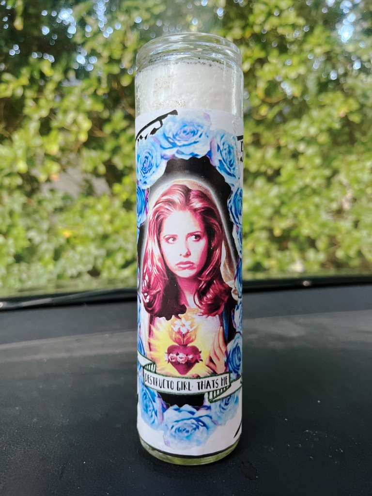 A candle with Buffy The Vampire on it.