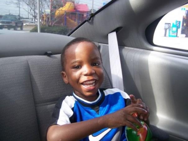 Young black boy smiling in a car