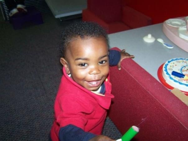 Black toddler playing at a museum